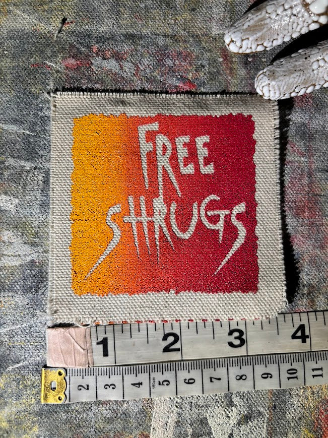 Free Shrugs sew on patch. never mind free hugs, you get free shrugs.