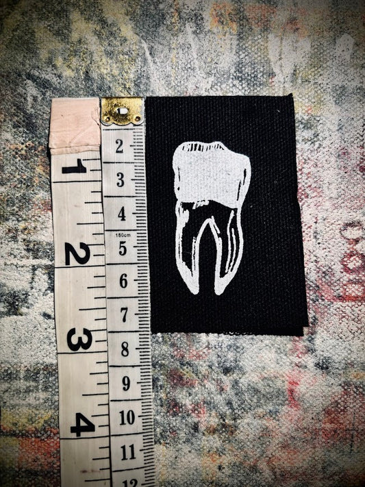 loose tooth patch. a mini patch with one toof.