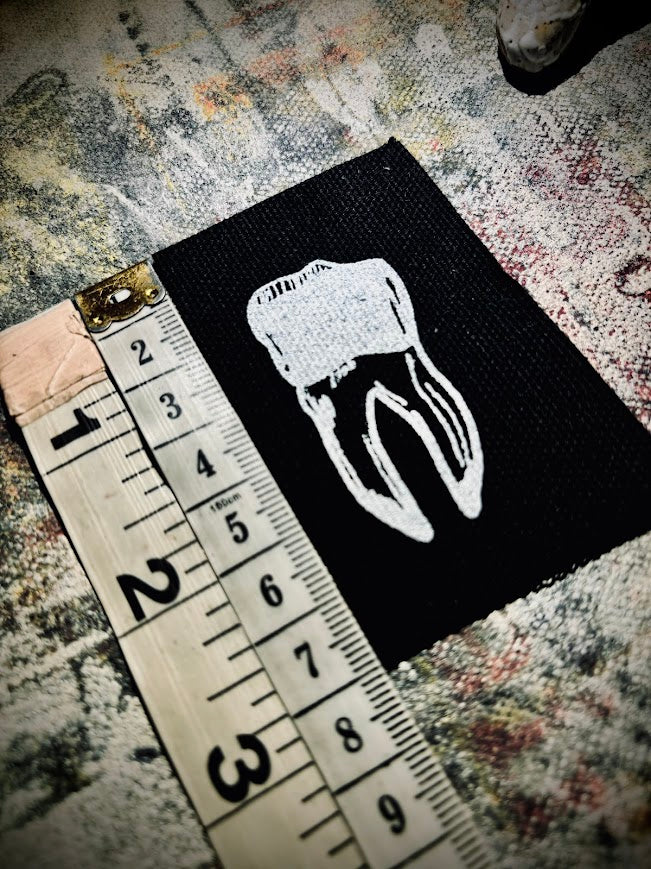 loose tooth patch. a mini patch with one toof.