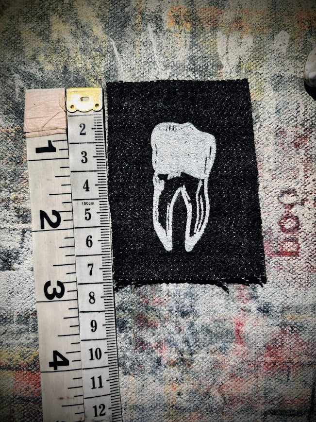 loose tooth patch. a mini patch with one toof.