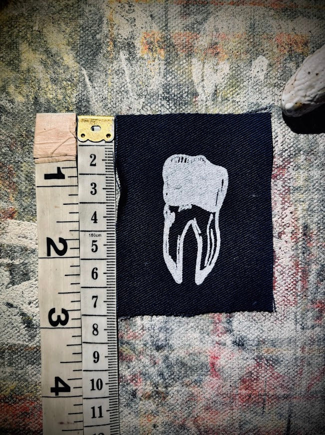 loose tooth patch. a mini patch with one toof.