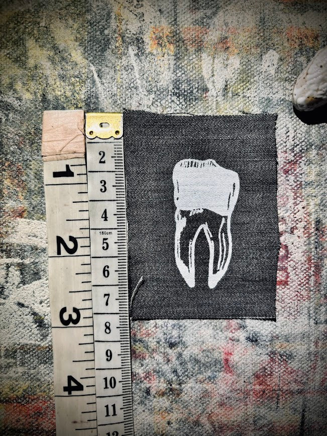 loose tooth patch. a mini patch with one toof.