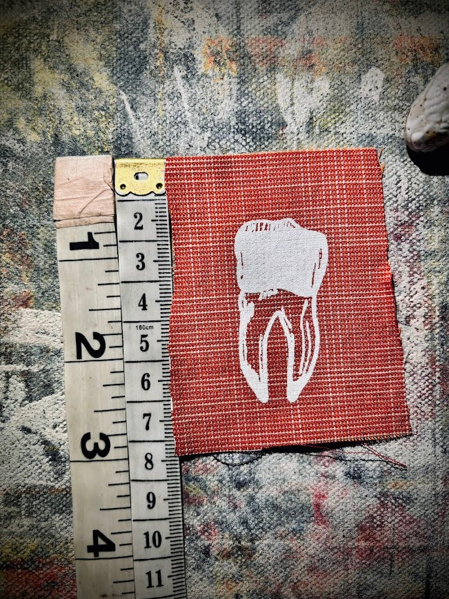 loose tooth patch. a mini patch with one toof.