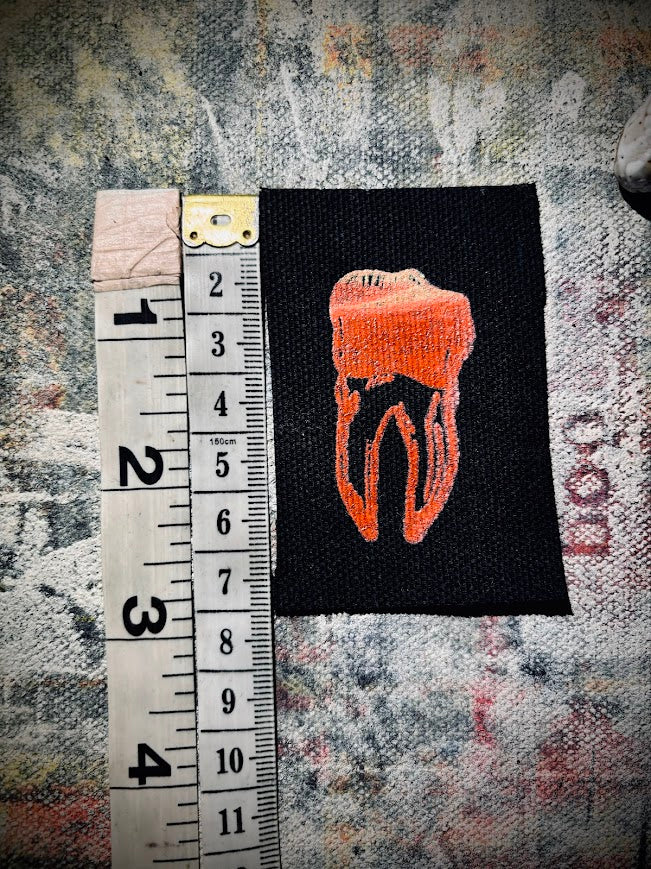 loose tooth patch. a mini patch with one toof.